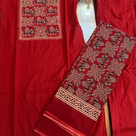 A vibrant red ethnic outfit featuring intricate elephant embroidery on the kurta, accompanied by matching pants and a patterned scarf.