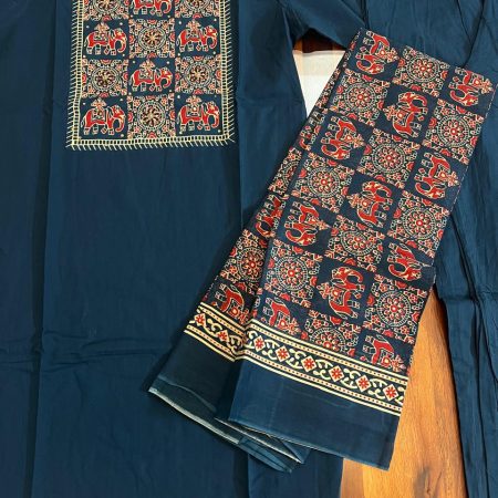 A navy blue kurta with intricate elephant motif embroidery on the neckline and matching patterned pants displayed on a wooden surface.